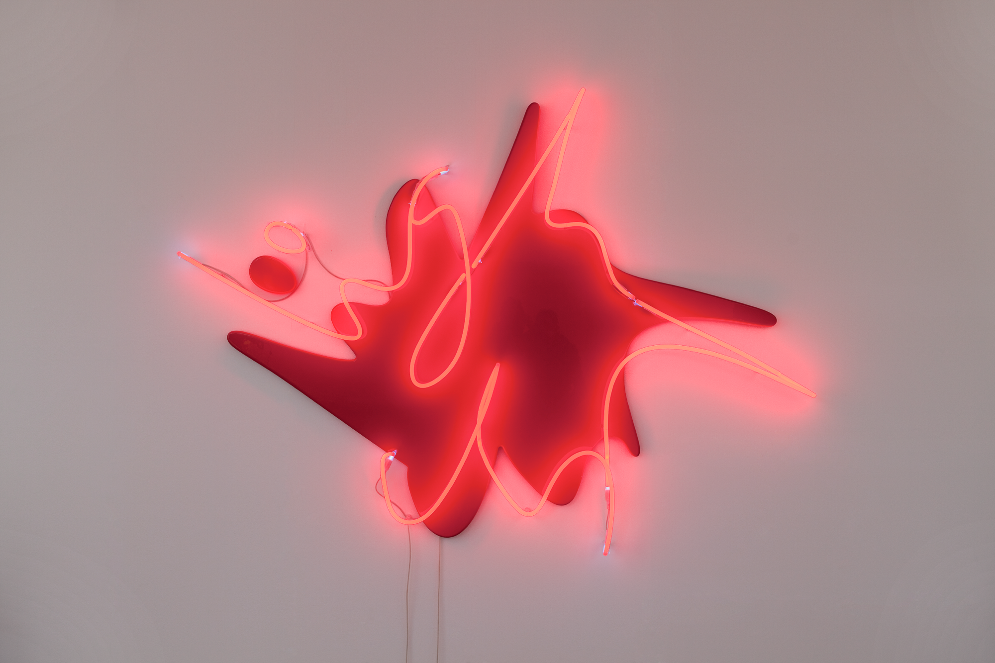 Neon Leuchtschild, das wie eine Sprechblase aussieht, auf deren Rand in geschwungener Schrift ,,Light up'' steht.